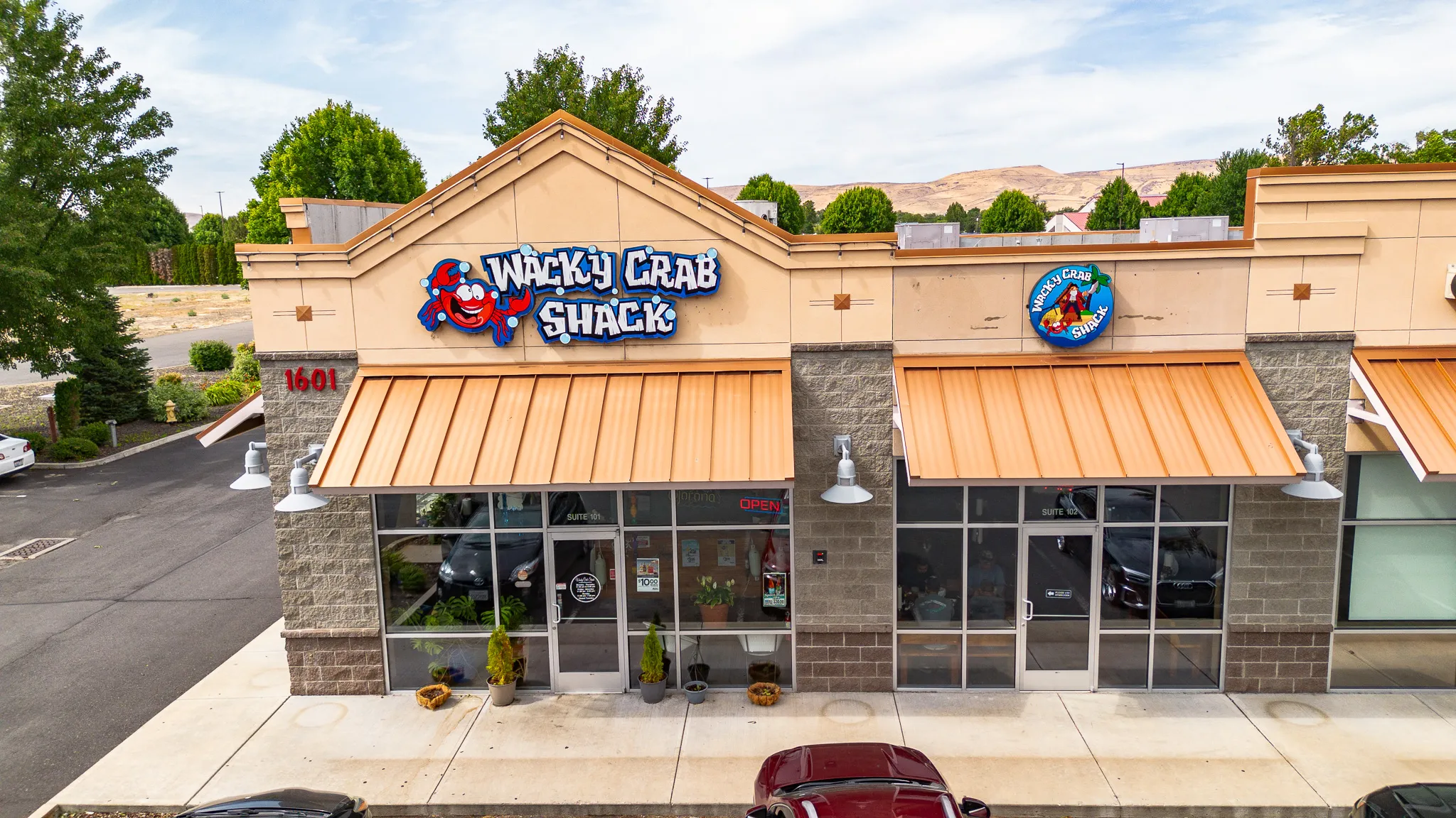 Aerial of the Wacky Crab Shack building and surrounding parking on East Washington Avenue